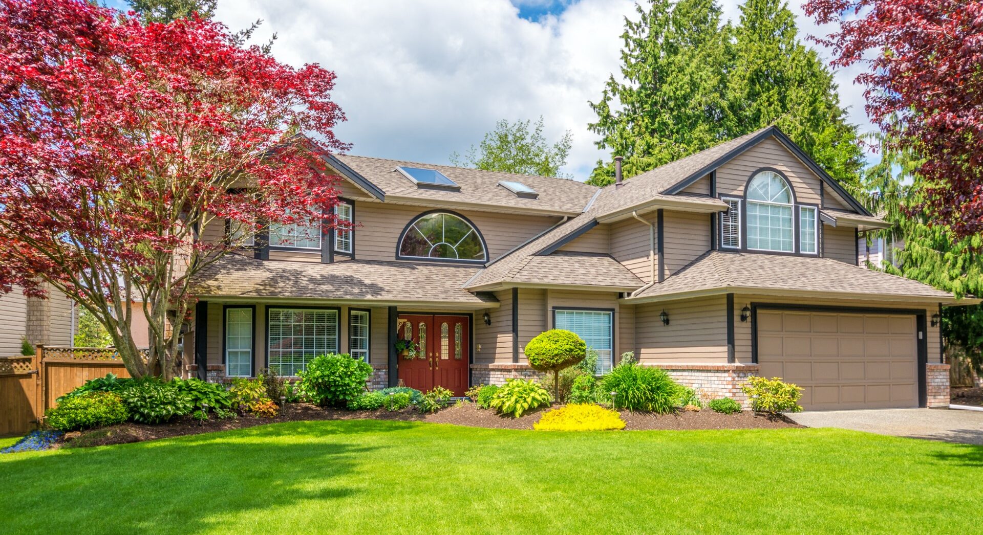 Landscaped front yard with layered greenery and curb appeal.